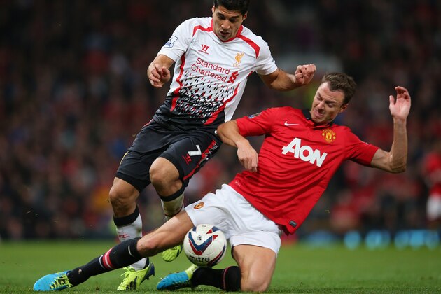 MANCHESTER, ENGLAND - SEPTEMBER 25: Jonny Evans of Manchester United tackles Luis Suarez of Liverpool during the Capital One Cup Third Round match betwen Manchester United and Liverpool at Old Trafford on September 25, 2013 in Manchester, England. (Photo by Julian Finney/Getty Images) MANCHESTER, ENGLAND - SEPTEMBER 25: Jonny Evans of Manchester United tackles Luis Suarez of Liverpool during the Capital One Cup Third Round match betwen Manchester United and Liverpool at Old Trafford on September 25, 2013 in Manchester, England. (Photo by Julian Finney/Getty Images)