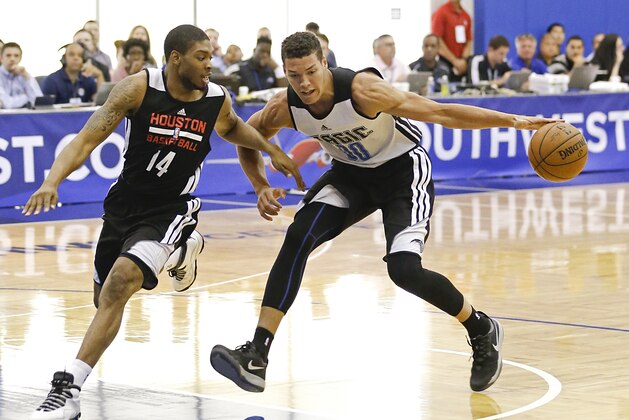 Orlando Magic's Aaron Gordon, right, tries to get around Houston Rockets' Jermaine Marshall (14) during an NBA summer league basketball game in Orlando, Fla., Monday, July 7, 2014. (AP Photo/John Raoux)