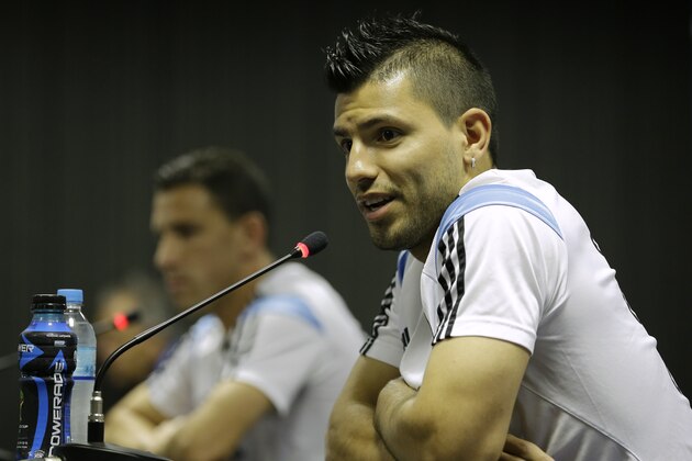 Argentina's Sergio Aguero, right, speaks during a news conference next to teammate Maxi Rodriguez, left, in Vespesiano, near Belo Horizonte, Brazil, Thursday, July 10, 2014. On Sunday, Argentina faces Germany for the World Cup final soccer match in Rio de Janeiro. (AP Photo/Victor R. Caivano)