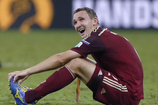 Russia's Alexei Kozlov reacts at the end of the group H World Cup soccer match between Algeria and Russia at the Arena da Baixada in Curitiba, Brazil, Thursday, June 26, 2014. With Algeria and Russia playing to a 1-1 draw, Algeria qualified for the knock-out stage, eliminating Russia.(AP Photo/Jon Super)