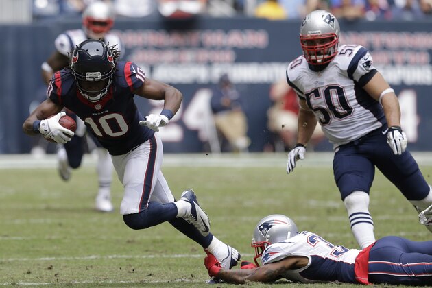 Houston Texans wide receiver DeAndre Hopkins (10) is tripped up by a New England Patriots defender during the second quarter of an NFL football game Sunday, Dec. 1, 2013, in Houston. (AP Photo/Patric Schneider)
