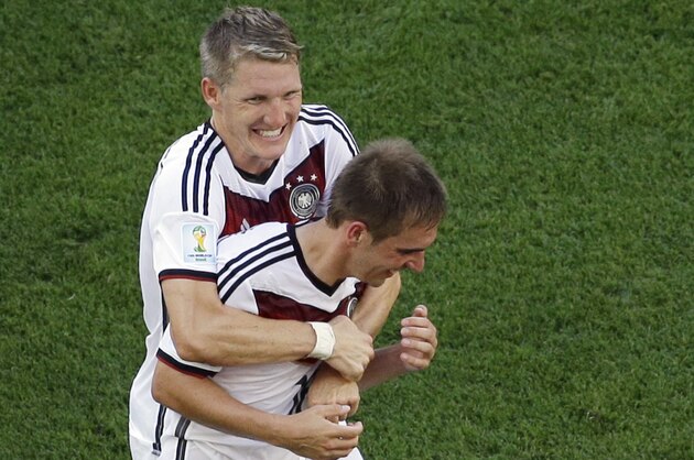 Germany's Philipp Lahm, right, and Bastian Schweinsteiger celebrate after the World Cup quarterfinal soccer match between Germany and France at the Maracana Stadium in Rio de Janeiro, Brazil, Friday, July 4, 2014. Germany won 1-0. (AP Photo/Matt Dunham, pool)