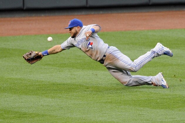 A ball hit by Baltimore Orioles' Manny Machado for a double gets by Toronto Blue Jays left fielder Melky Cabrera during the second inning of a baseball game on Friday, June 13, 2014, in Baltimore. (AP Photo/Nick Wass)