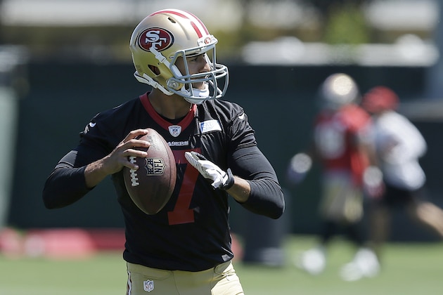 San Francisco 49ers quarterback Colin Kaepernick passes during NFL football minicamp in Santa Clara, Calif., Thursday, June 19, 2014. (AP Photo/Jeff Chiu)