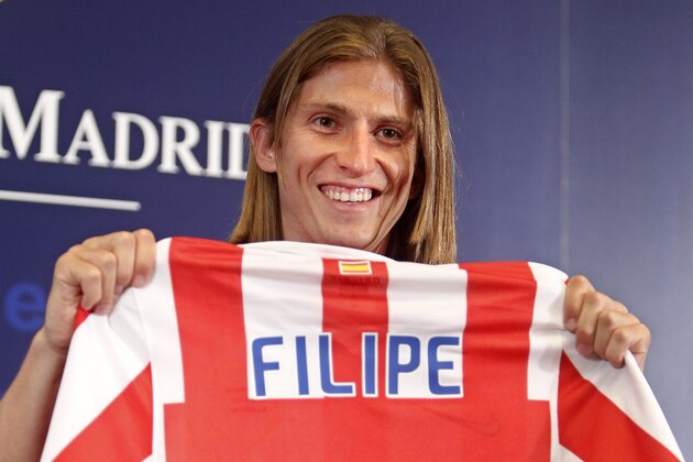 Felipe Luis of Brazil holds up his new jersey after signing for Atletico de Madrid, at the Vicente Calderon stadium in Madrid Tuesday, July 27, 2010. Luis previously played for  Deportivo la Coruna. (AP Photo/Paul White)