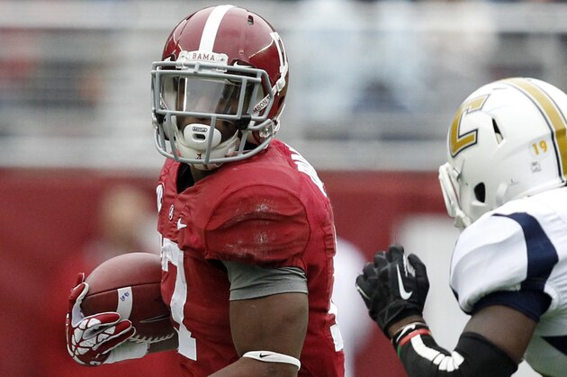Alabama running back Kenyan Drake (17) tries to get around Chattanooga defensive back Dee Virgin (19) as he carries the ball during the first half of an NCAA college football game on Saturday, Nov. 23, 2012, in Tuscaloosa, Ala. (AP Photo/Butch Dill)