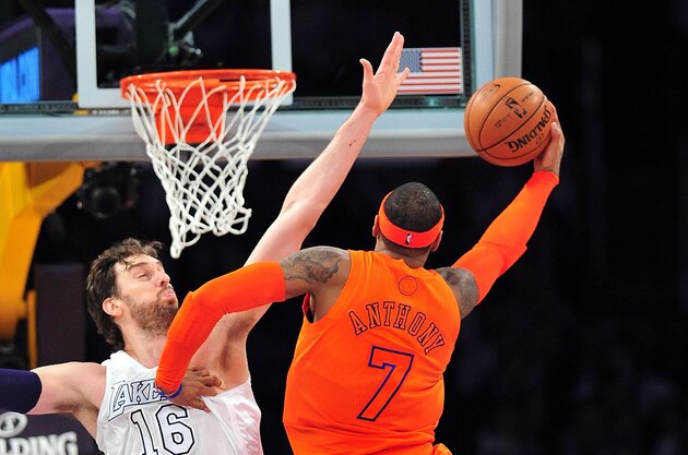 December 25, 2012; Los Angeles, CA, USA; New York Knicks small forward Carmelo Anthony (7) goes in for a basket against the defense of Los Angeles Lakers power forward Pau Gasol (16) during the second half at Staples Center. Mandatory Credit: Gary A. Vasquez-USA TODAY Sports