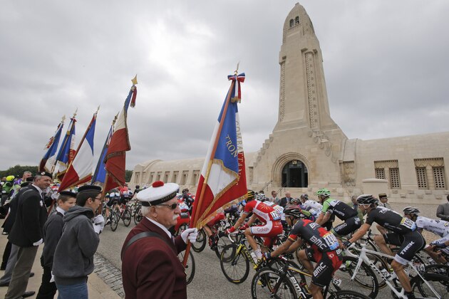 The pack passes the Verdun War Memorial, which commemorates the Battle of Verdun fought in 1916 as part of there first World War, during the seventh stage of the Tour de France cycling race over 234.5 kilometers (145.7 miles) with start in Epernay and finish in Nancy, France, Friday, July 11, 2014. (AP Photo/Christophe Ena)