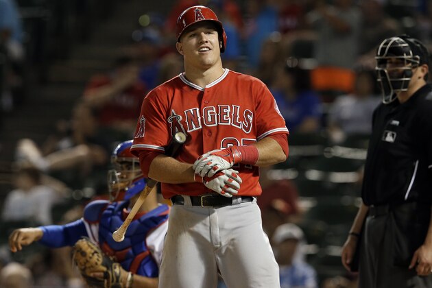 Los Angeles Angels' Mike Trout adjust his gloves between pitches from Texas Rangers' Aaron Poreda in the eighth inning of a baseball game, Thursday, July 10, 2014, in Arlington, Texas. (AP Photo/Tony Gutierrez)