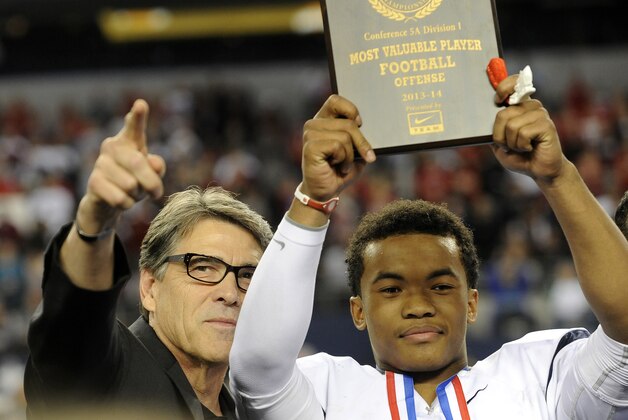 Texas Gov. Rick Perry, left, poses for photos with the most valuable player,  offensive, Allen quarterback Kyler Murray, following a 63-28 win over Pearland during a UIL Class 5A  Division I high school football championship game on Saturday, Dec. 21, 2013, in Arlington, Texas. (AP Photo/Matt Strasen)