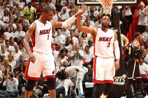 MIAMI, FL - MAY 6: Chris Bosh #1 and Dwyane Wade #3 of the Miami Heat celebrates in Game One of the Eastern Conference Semi-Finals against the Brooklyn Nets during the 2014 NBA Playoffs at American Airlines Arena on May 6, 2014 in Miami, Florida. NOTE TO USER: User expressly acknowledges and agrees that, by downloading and/or using this Photograph, user is consenting to the terms and conditions of the Getty Images License Agreement. Mandatory Copyright Notice: Copyright 2014 NBAE (Photo by Issac Baldizon/NBAE via Getty Images)