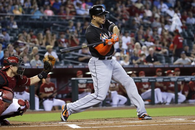 Miami Marlins' Giancarlo Stanton hits against the Arizona Diamondbacks during the first inning of a baseball game, Wednesday, July 9, 2014, in Phoenix. (AP Photo/Matt York)