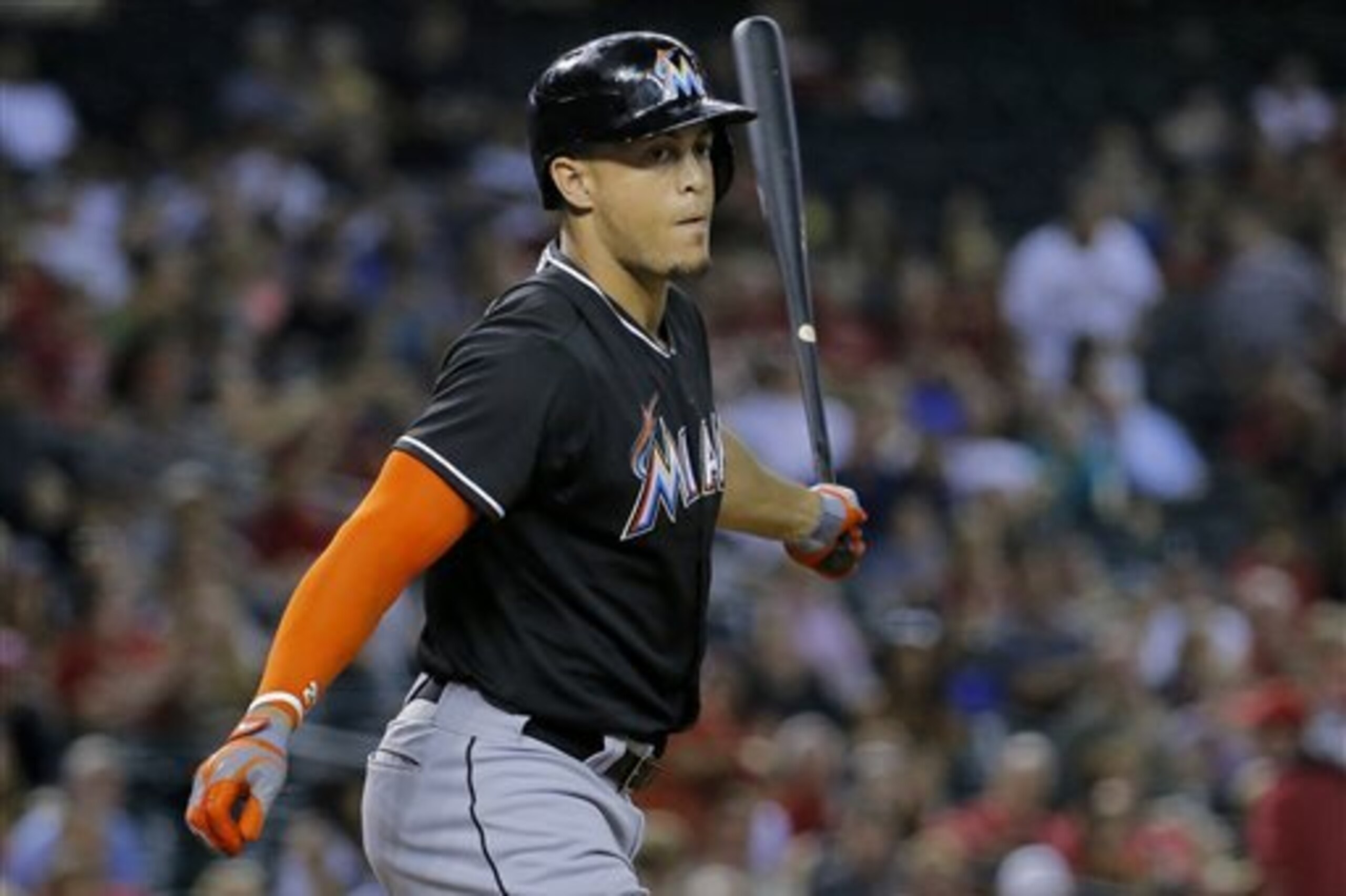 Miami Marlins' Giancarlo Stanton tosses his bat after striking out against the Arizona Diamondbacks during the second inning of a baseball game, Monday, July 7, 2014, in Phoenix. (AP Photo/Matt York)