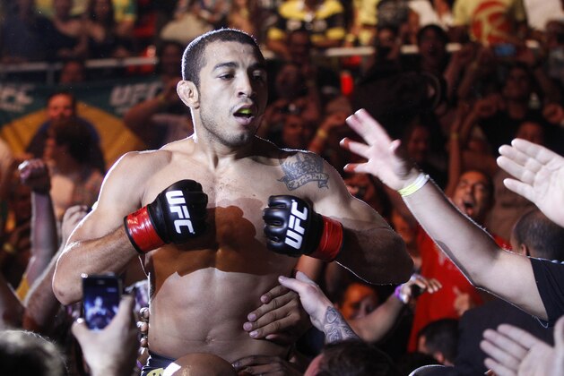 Defending featherweight champion Jose Aldo, from Brazil, celebrates with fans after defeating Chad Mendes, from the US, on the first round during their featherweight title bout at the Ultimate Fighting Championship (UFC) 142 in Rio de Janeiro, Brazil, Sunday Jan. 15, 2012. (AP Photo/Felipe Dana) Defending featherweight champion Jose Aldo, from Brazil, celebrates with fans after defeating Chad Mendes, from the US, on the first round during their featherweight title bout at the Ultimate Fighting Championship (UFC) 142 in Rio de Janeiro, Brazil, Sunday Jan. 15, 2012. (AP Photo/Felipe Dana)