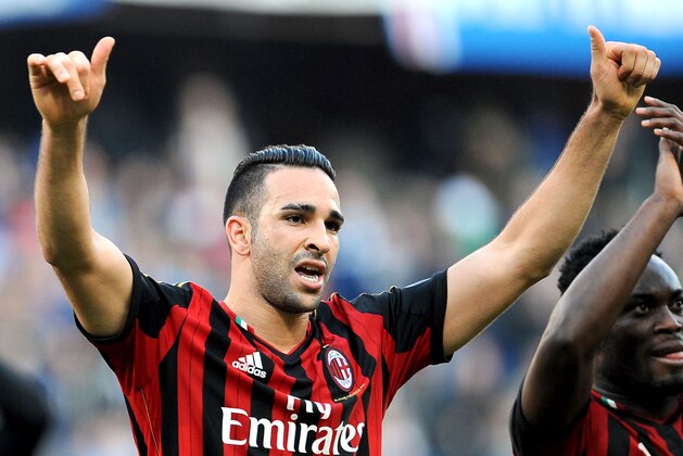 AC Milan's Adil Rami, left, and teammate Michael Essien celebrate at the end of a Serie A soccer match between Sampdoria and AC Milan, at the Luigi Ferraris stadium in Genoa, Italy, Sunday, Feb. 23, 2014. AC Milan won 2-0. (AP Photo/Carlo Baroncini)
