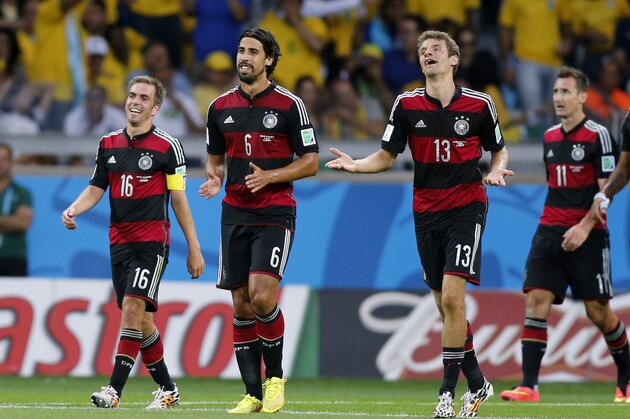 Germany's Philipp Lahm, Sami Khedira, Thomas Mueller and Miroslav Klose, from left, smile after their team scored during the World Cup semifinal soccer match between Brazil and Germany at the Mineirao Stadium in Belo Horizonte, Brazil, Tuesday, July 8, 2014. (AP Photo/Frank Augstein)