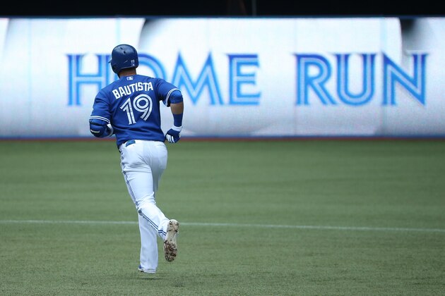 TORONTO, CANADA - JULY 2: Jose Bautista #19 of the Toronto Blue Jays circles the bases after hitting a solo home run in the first inning during MLB game action against the Milwaukee Brewers on July 2, 2014 at Rogers Centre in Toronto, Ontario, Canada. (Photo by Tom Szczerbowski/Getty Images)