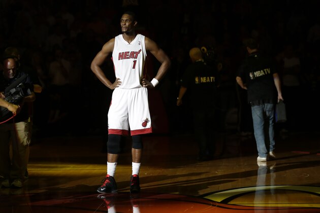 Miami Heat's Chris Bosh (1) stands during team introductions before an NBA basketball game against the Golden State Warriors, Thursday, Jan. 2, 2014, in Miami. (AP Photo/Lynne Sladky)