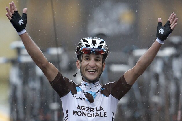 France's Blel Kadri crosses the finish line to win the eighth stage of the Tour de France cycling race over 161 kilometers (100 miles) with start in Tomblaine and finish in Gerardmer, France, Saturday, July 12, 2014. (AP Photo/Peter Dejong)