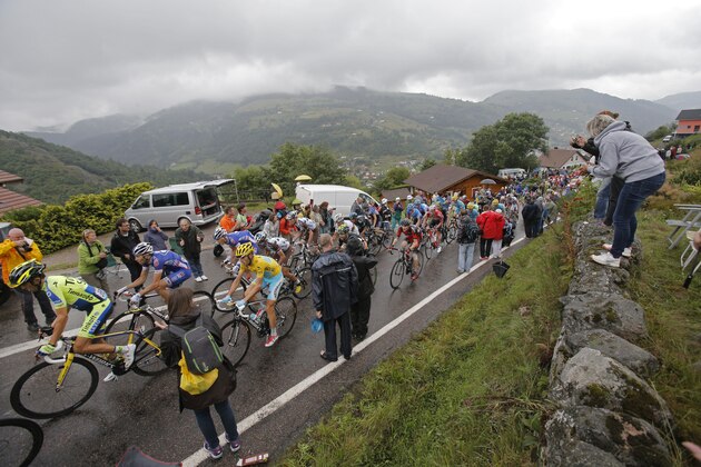The pack with Spain's Alberto Contador, left, and Italy's Vincenzo Nibali, wearing the overall leader's yellow jersey, climbs during the eighth stage of the Tour de France cycling race over 161 kilometers (100 miles) with start in Tomblaine and finish in Gerardmer, France, Saturday, July 12, 2014. (AP Photo/Christophe Ena)