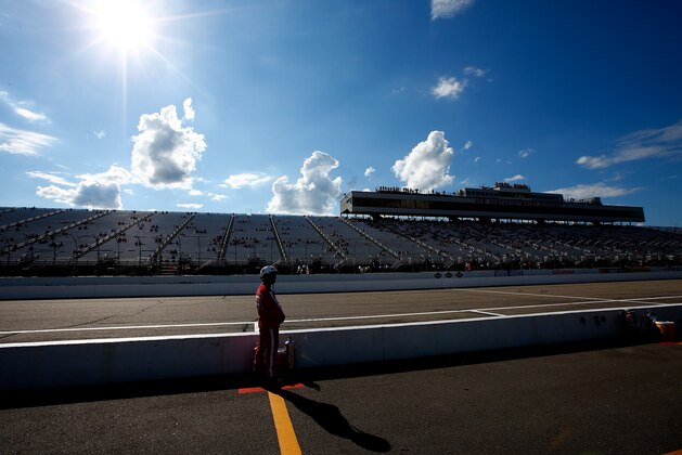LOUDON, NH - JULY 11: A safety worker stands ready during qualifying for the NASCAR Sprint Cup Series Camping World RV Sales 301 at New Hampshire Motor Speedway on July 11, 2014 in Loudon, New Hampshire.  (Photo by Jared Wickerham/Getty Images)