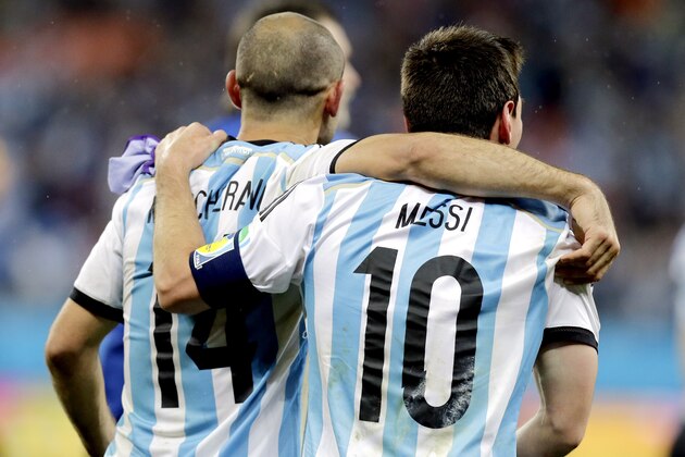 Argentina's Lionel Messi  (10) walks with Javier Mascherano (14) after Argentina defeated the Netherlands 4-2 in a penalty shootout after a 0-0 tie after extra time to advance to the finals during the World Cup semifinal soccer match between the Netherlands and Argentina at the Itaquerao Stadium in Sao Paulo Brazil, Wednesday, July 9, 2014. (AP Photo/Victor R. Caivano)