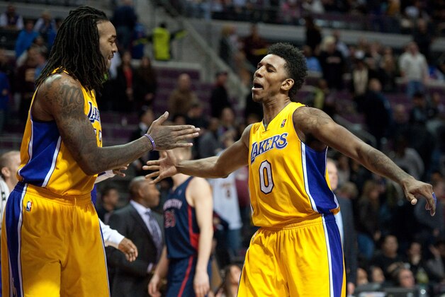 Nov 29, 2013; Auburn Hills, MI, USA; Los Angeles Lakers small forward Nick Young (0) and center Jordan Hill (27) celebrate their win over the Detroit Pistons at The Palace of Auburn Hills. Lakers won 106-102. Mandatory Credit: Tim Fuller-USA TODAY Sports