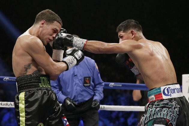 Abner Mares, right, lands a punch on Jonathan Oquendo during their featherweight fight , Saturday, July 12, 2014, in Las Vegas. (AP Photo/John Locher)