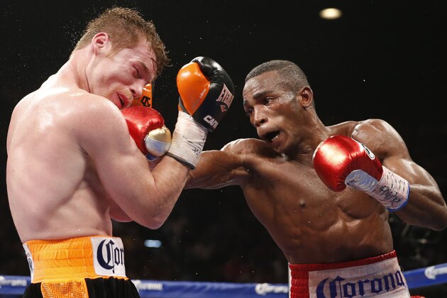 Canelo Alvarez, left, of Mexico, takes a hit from Erislandy Lara, of Cuba, during their super welterweight fight, Saturday, July 12, 2014, in Las Vegas. (AP Photo/Eric Jamison)
