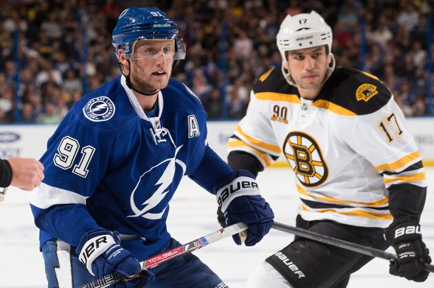 TAMPA, FL - OCTOBER 19: Linesman Pierre Racicot #65, Steven Stamkos #91 of the Tampa Bay Lightning, and Milan Lucic #17 of the Boston Bruins watch the play during tonight's game at the Tampa Bay Times Forum on October 19, 2013 in Tampa, Florida. (Photo by Scott Audette/NHLI via Getty Images)