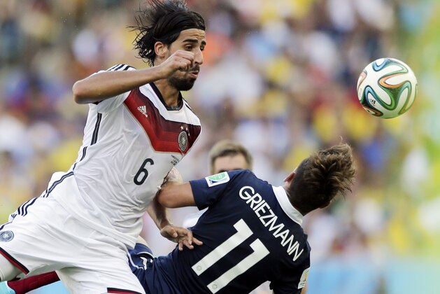 Germany's Sami Khedira heads the ball against France's Antoine Griezmann during the World Cup quarterfinal soccer match at the Maracana Stadium in Rio de Janeiro, Brazil, Friday, July 4, 2014. (AP Photo/Matthias Schrader)