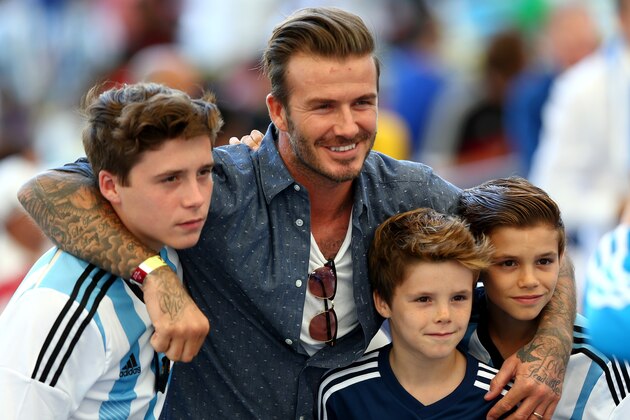 RIO DE JANEIRO, BRAZIL - JULY 13:  Former England international David Beckham and sons Brooklyn Beckham (L), Cruz Beckham (2nd R) and Romeo Beckham (R) prior to the 2014 FIFA World Cup Brazil Final match between Germany and Argentina at Maracana on July 13, 2014 in Rio de Janeiro, Brazil.  (Photo by Michael Steele/Getty Images)