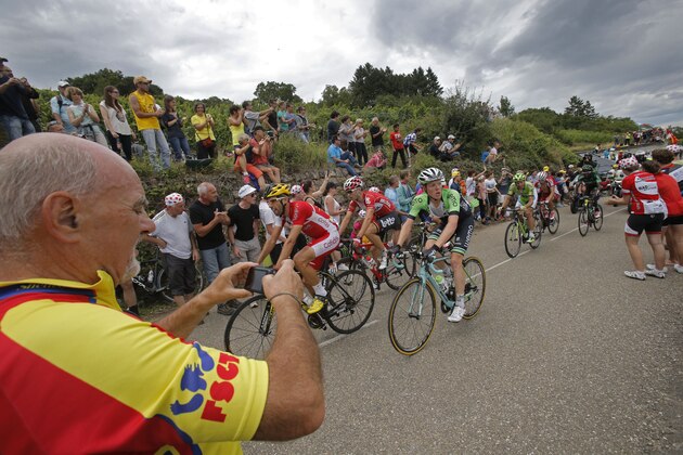 Stage winner France's Tony Gallopin, center rear in red shirt, Spain's Daniel Navarro, leading, and Netherland's Steven Kruijswijk, center in green shirt, climb during the ninth stage of the Tour de France cycling race over 170 kilometers (105.6 miles) with start in Gerardmer and finish in Mulhouse, France, Sunday, July 13, 2014. (AP Photo/Christophe Ena)