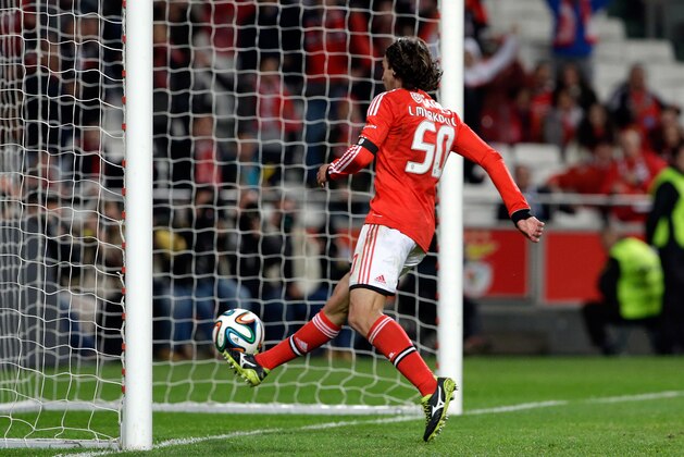 Benfica's Lazar Markovic, from Serbia, right, scores the opening goal after chipping the ball over the Guimaraes' goalkeeper during their Portuguese league soccer match Monday, Feb. 24 2014, at Benfica's Luz stadium in Lisbon. (AP Photo/Armando Franca) Benfica's Lazar Markovic, from Serbia, right, scores the opening goal after chipping the ball over the Guimaraes' goalkeeper during their Portuguese league soccer match Monday, Feb. 24 2014, at Benfica's Luz stadium in Lisbon. (AP Photo/Armando Franca)