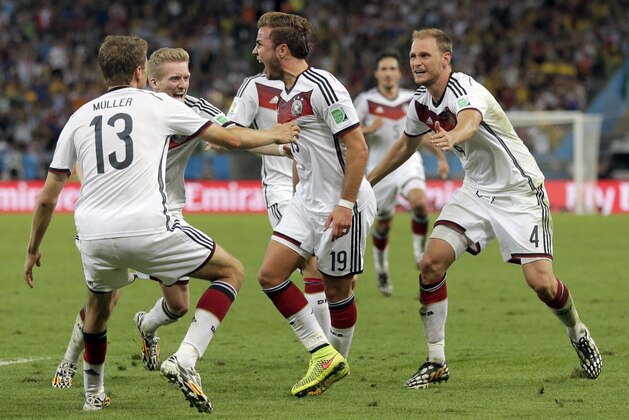 Germany's Mario Goetze (19) celebrates with teammates after scoring his side's first goal in extra time against Argentina's goalkeeper Sergio Romero during the World Cup final soccer match between Germany and Argentina at the Maracana Stadium in Rio de Janeiro, Brazil, Sunday, July 13, 2014. (AP Photo/Felipe Dana)