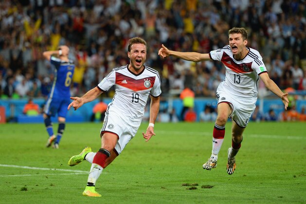 RIO DE JANEIRO, BRAZIL - JULY 13:  Mario Goetze of Germany (L) celebrates scoring his team's first goal with Thomas Mueller during the 2014 FIFA World Cup Brazil Final match between Germany and Argentina at Maracana on July 13, 2014 in Rio de Janeiro, Brazil.  (Photo by Jamie McDonald/Getty Images)