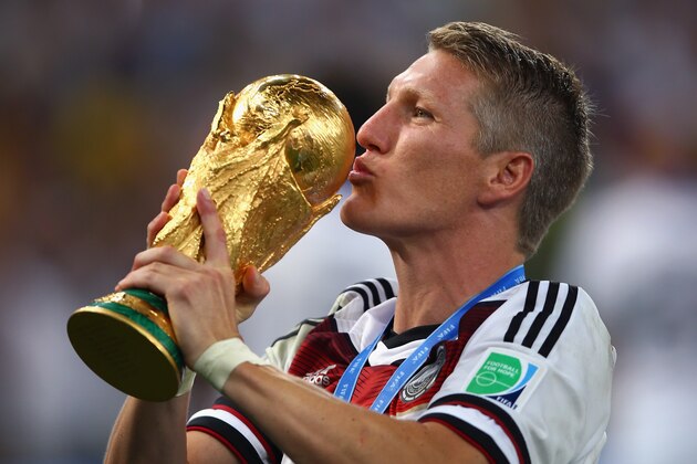 RIO DE JANEIRO, BRAZIL - JULY 13:  Bastian Schweinsteiger of Germany kisses the World Cup trophy after defeating Argentina 1-0 in extra time during the 2014 FIFA World Cup Brazil Final match between Germany and Argentina at Maracana on July 13, 2014 in Rio de Janeiro, Brazil.  (Photo by Clive Rose/Getty Images)
