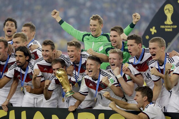 German players celebrate with the World Cup trophy following their 1-0 victory over Argentina after the World Cup final soccer match between Germany and Argentina at the Maracana Stadium in Rio de Janeiro, Brazil, Sunday, July 13, 2014. (AP Photo/Natacha Pisarenko)