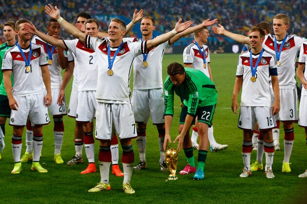 RIO DE JANEIRO, BRAZIL - JULY 13:  Germany celebrate after defeating Argentina 1-0 in extra time during the 2014 FIFA World Cup Brazil Final match between Germany and Argentina at Maracana on July 13, 2014 in Rio de Janeiro, Brazil.  (Photo by Clive Rose/Getty Images)