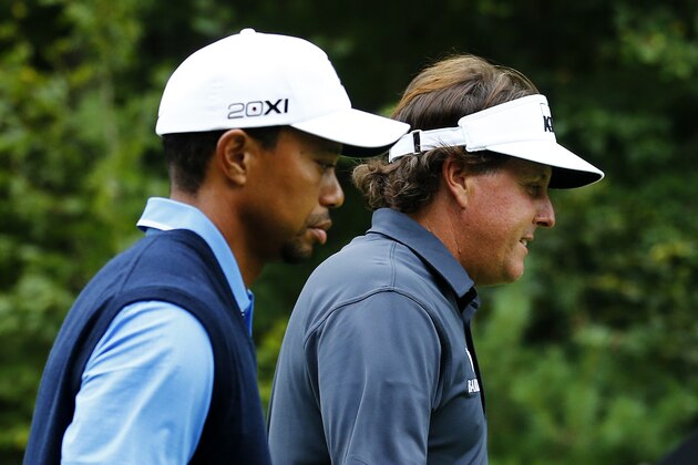 NORTON, MA - AUGUST 30:  Tiger Woods (L) and Phil Mickelson of the USA walk on the 12th hole during the first round of the Deutsche Bank Championship at TPC Boston on August 30, 2013 in Norton, Massachusetts.  (Photo by Jim Rogash/Getty Images)