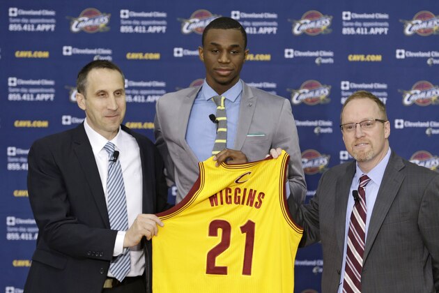 Cleveland Cavaliers head coach David Blatt, left to right, Andrew Wiggins and general manager David Griffin hold up Wiggins jersey during a new conference Friday, June 27, 2014, in Independence, Ohio. (AP Photo/Tony Dejak)