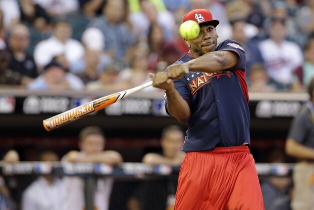 Rapper Nelly swings during the All-Star Legends & Celebrity Softball Game Sunday, July 13, 2014, in Minneapolis. (AP Photo/Paul Sancya)