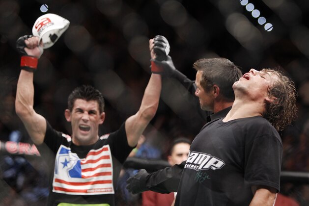 Dominick Cruz, left, celebrates his victory over Urijah Faber shortly after their UFC bantamweight mixed martial arts title match, Saturday, July 2, 2011 at The MGM Grand Garden Arena in Las Vegas. Cruz won by unanimous decision. (AP Photo/Eric Jamison)