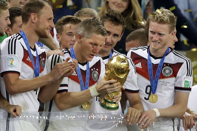 Germany's Bastian Schweinsteiger looks at the trophy after the World Cup final soccer match between Germany and Argentina at the Maracana Stadium in Rio de Janeiro, Brazil, Sunday, July 13, 2014. Germany beat Argentina 1-0 to win the World Cup. (AP Photo/Victor R. Caivano)