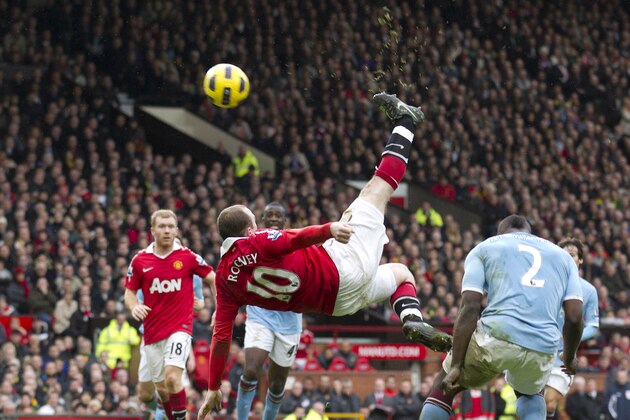 FILE - In this Feb. 12, 2011, file photo, Manchester United's Wayne Rooney, center, scores the game-winning goal with an overhead kick against Manchester City during their English Premier League soccer match at Old Trafford Stadium, Manchester, England. Rooney's fantastic finish is featured on the 10-goal shortlist published by FIFA on Friday, Nov. 18, 2011, competing to be chosen as the best score in 2011. (AP Photo/Jon Super, File)