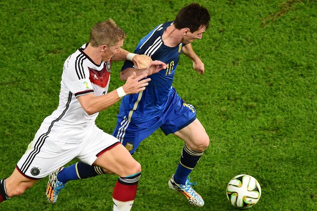 RIO DE JANEIRO, BRAZIL - JULY 13: Bastian Schweinsteiger of Germany challenges Lionel Messi of Argentina during the 2014 FIFA World Cup Brazil Final match between Germany and Argentina at Maracana on July 13, 2014 in Rio de Janeiro, Brazil.  (Photo by Francois Xavier Marit - Pool/Getty Images)