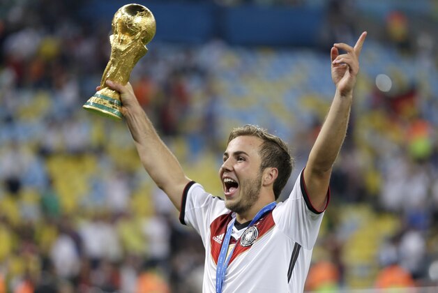 Germany's Mario Goetze, who scored the winning goal, holds the World Cup trophy following their 1-0 victory over Argentina after the World Cup final soccer match between Germany and Argentina at the Maracana Stadium in Rio de Janeiro, Brazil, Sunday, July 13, 2014. (AP Photo/Natacha Pisarenko)
