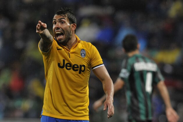 Juventus's Carlos Tevez of Argentina gestures during their Serie A soccer match against Sassuolo, at Reggio Emilia's Mapei stadium, Italy, Monday, April 28, 2014. Juventus won 3 - 1.(AP Photo/Marco Vasini)