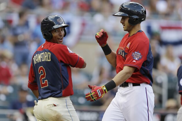 United States' Joey Gallo, right, celebrates with teammate J.P. Crawford, left, after hitting a two-run home run during the sixth inning of the All-Star Futures baseball game against Team World, Sunday, July 13, 2014, in Minneapolis. (AP Photo/Jeff Roberson)