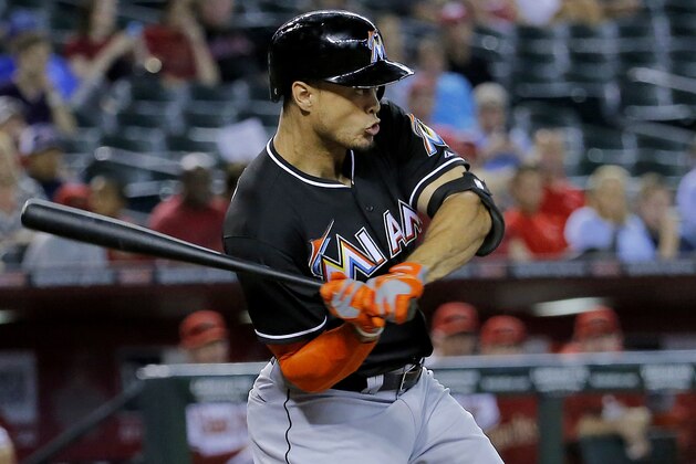 Florida Marlins' Giancarlo Stanton hits against the Arizona Diamondbacks during the first inning of a baseball game, Monday, July 7, 2014, in Phoenix. (AP Photo/Matt York)
